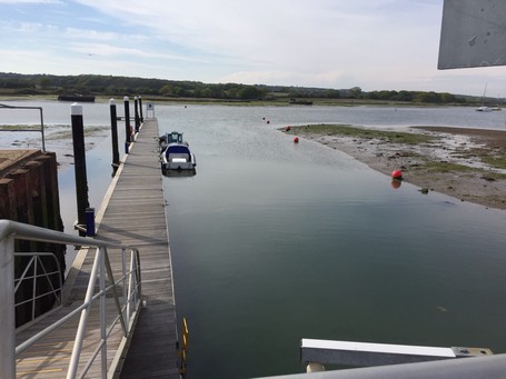 mud banks at entrance to island harbour marina at low water